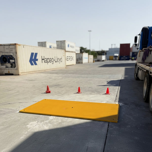 Yellow nonslip coated road plate at container storage site
